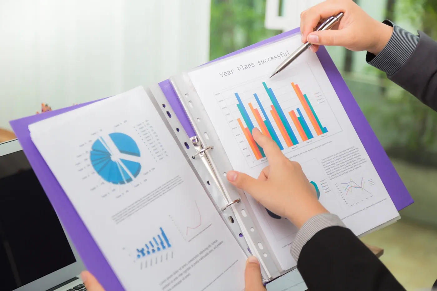 men suit analyzing results chart